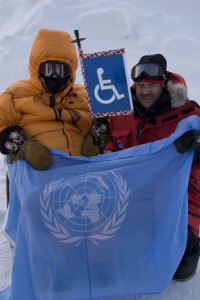  Chris Watkins and Dave Shannon, for the first time in history, planted a wheelchair access sign on the North Pole. Seen here is their sign and the United Nations Flag.