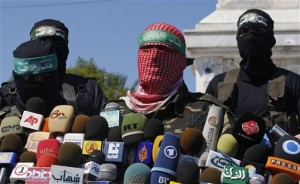 Masked Palestinian Hamas militants speak to the press during a press conference in Gaza City, Wednesday, Sept. 30, 2009. Israel and Hamas militants announced a deal Wednesday that will see Israel release 20 Palestinian women from prison this week in exchange for a videotape proving that a captive Israeli soldier held in the Gaza Strip is still alive. The decision was the first tangible sign of movement in more than three years of talks over the release of the soldier, Sgt. Gilad Schalit, who has not been seen since he was captured by Hamas-linked militants in a cross-border raid in June 2006. (AP Photo/Hatem Moussa)